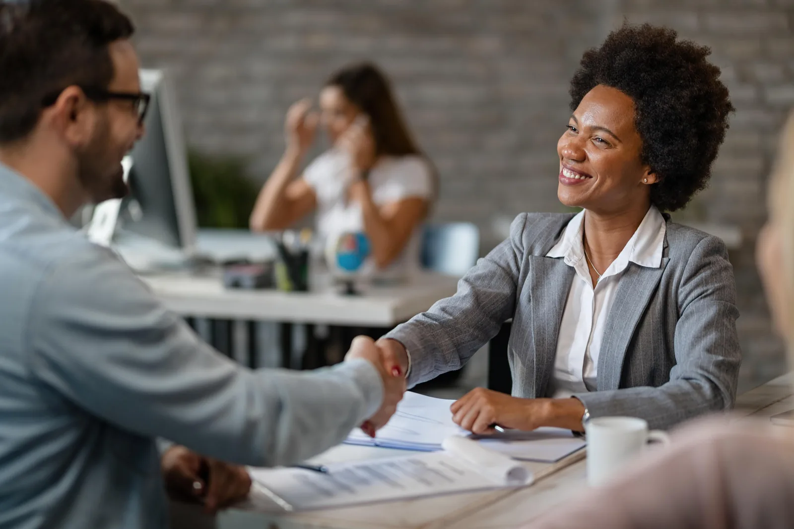 An advocate shaking hands with a client